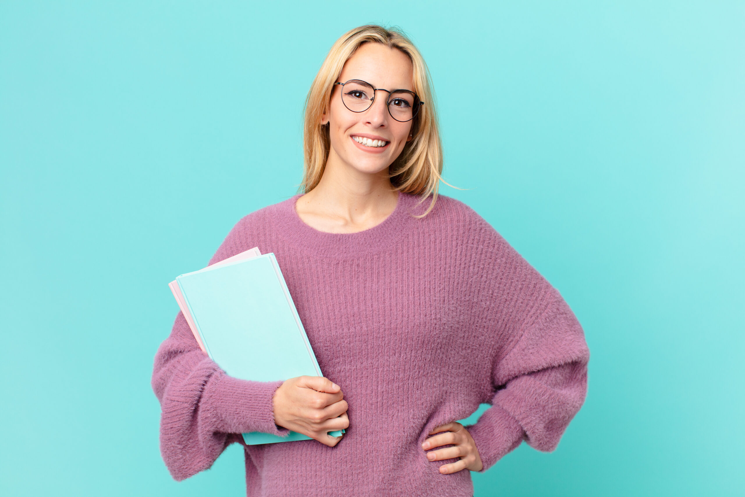 blonde pretty woman with books studing