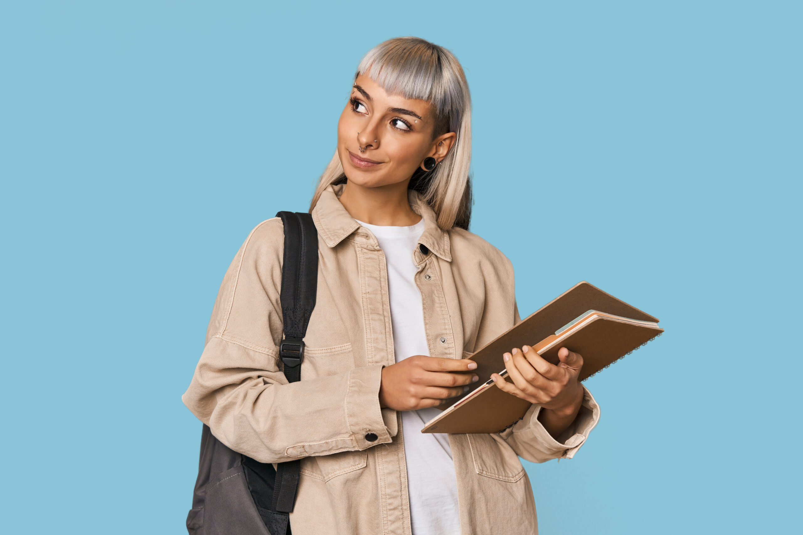 young caucasian student with a notebook